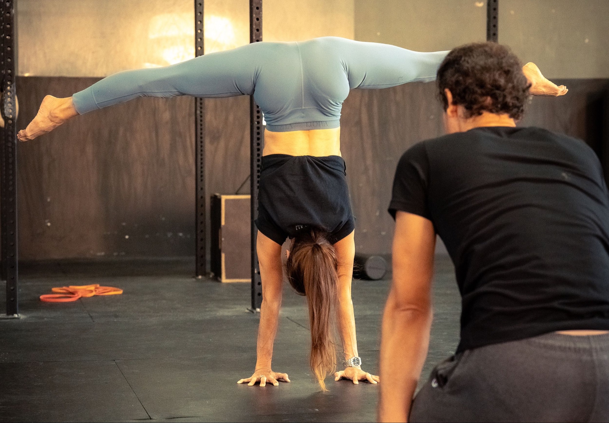 A THS coach spotting a student's handstand